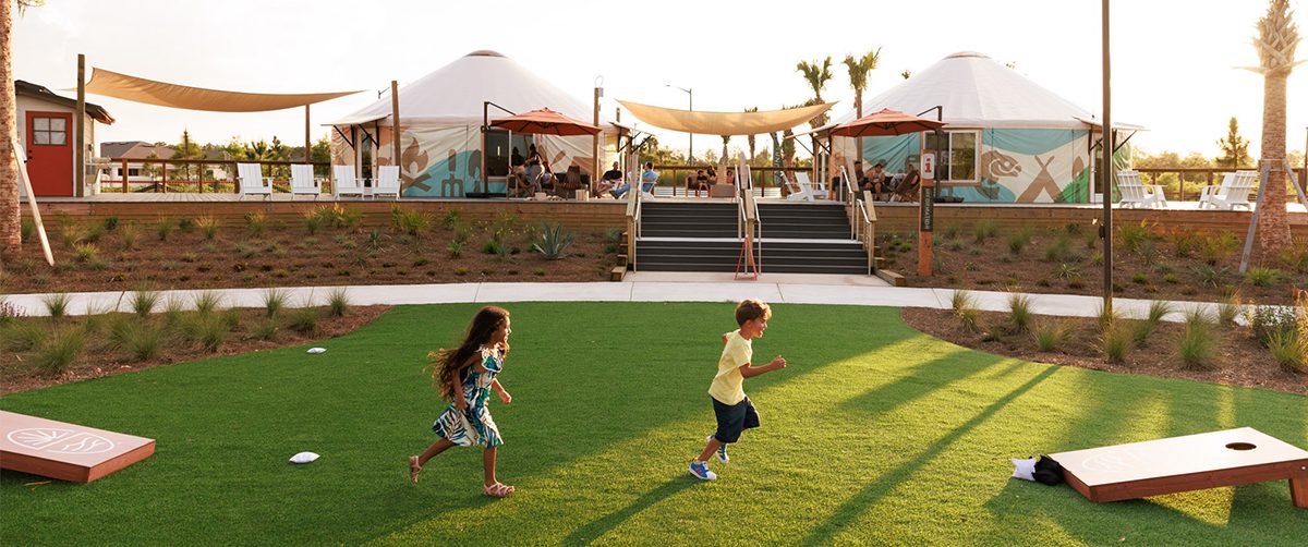 Children running on turf in a park